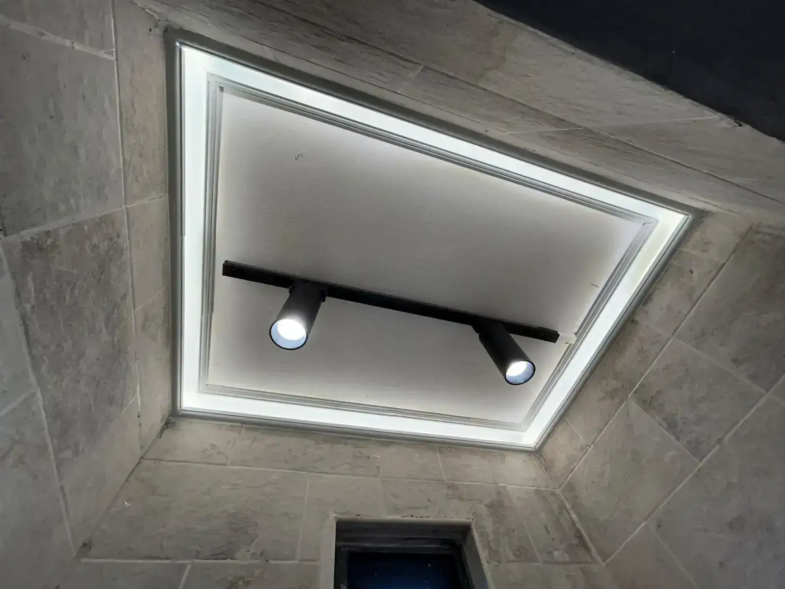 Layered bathroom ceiling lighting with spotlights