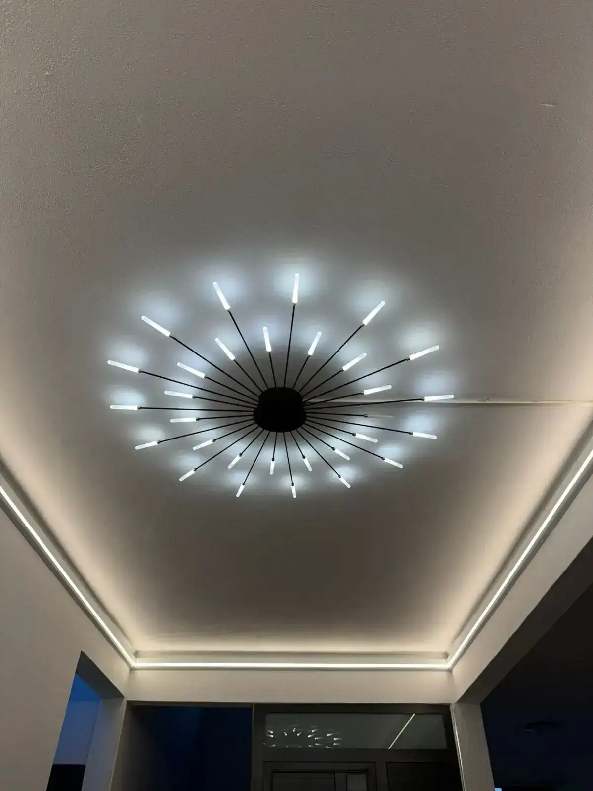 Cove lighting surrounding a decorative chandelier