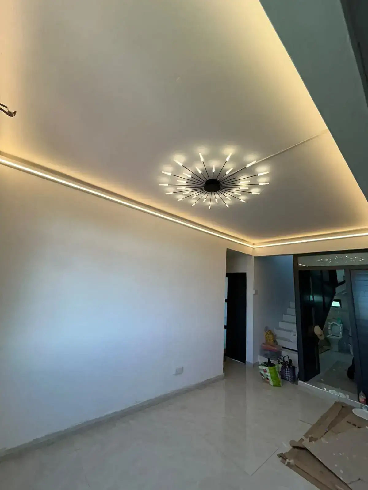 Completed living space with warm integrated cove lighting
